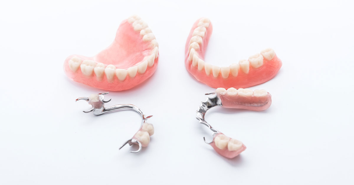 Set of full and partial dentures against a white background
