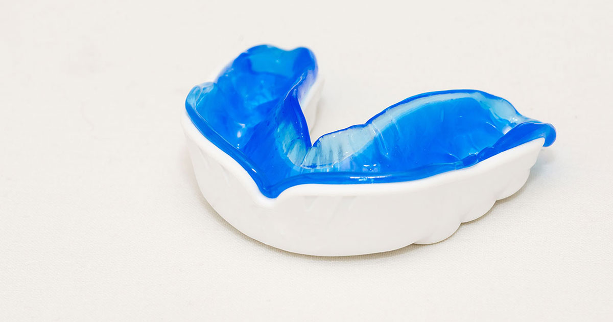 Blue and white mouth guard on white background.